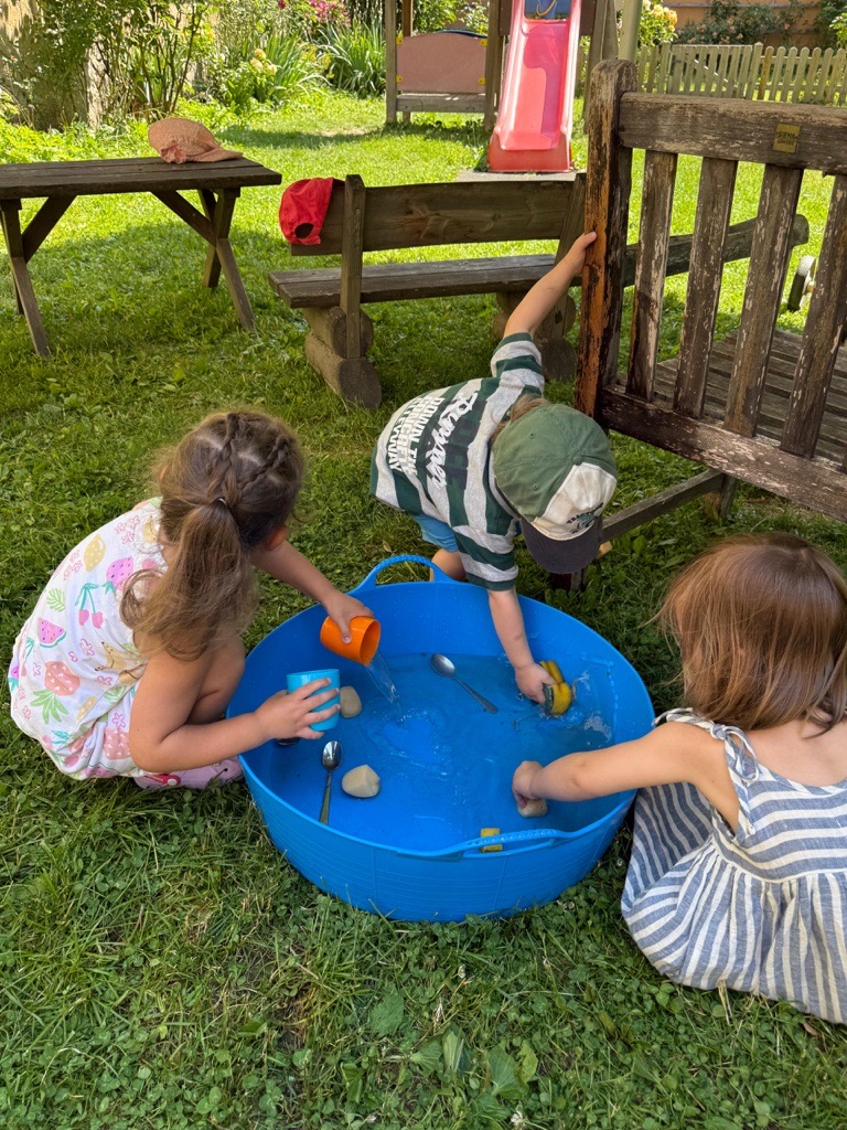 Kinder spielen mit Wasser